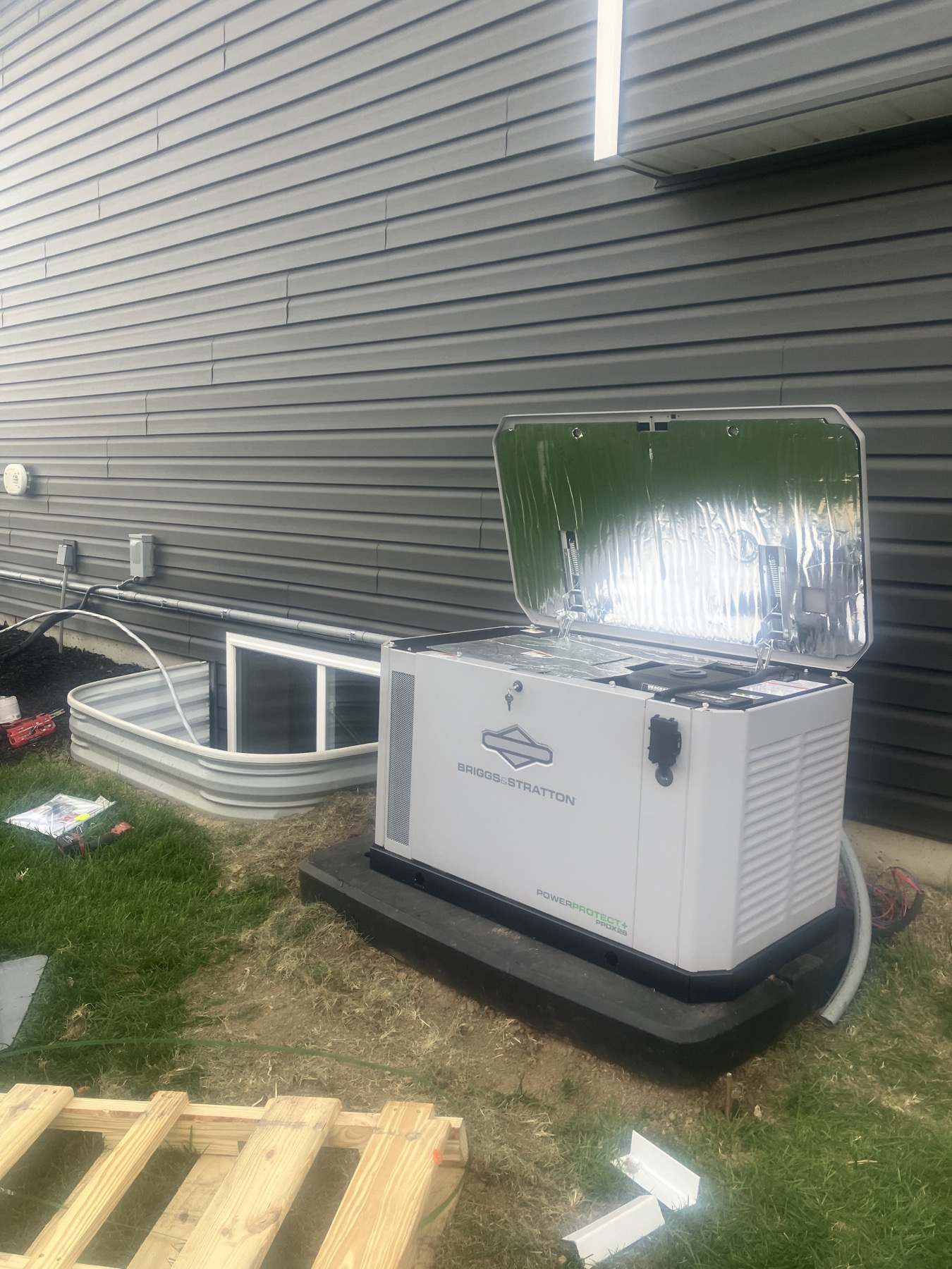 Greystone St. Joseph generator installation with open generator lid